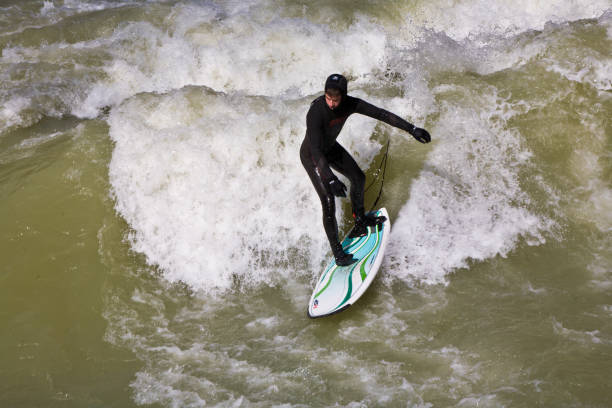 Young woman hydrospeeding in alpine river. River Sesia in Valsesia, Piedmont, Italy.