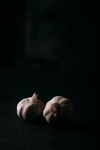 istock Garlic in the black background 1441180323