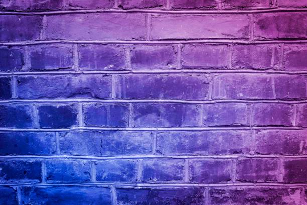 istock Toned blue and purple brick wall surface. Neon effect ot background. Grunge backdrop. 1441181826