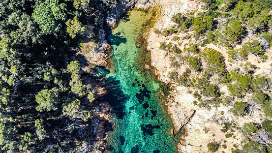 An aerial shot of the beautiful nature in Cala Bona, Tossa de Mar, Spain