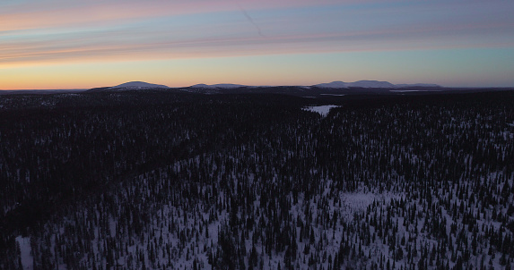 Aerial drone  view of forest and the Pallas mountains and polar night colors, in Lapland