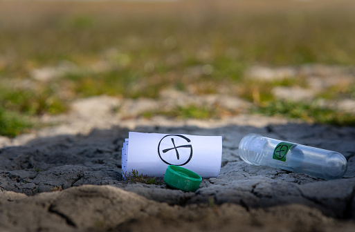 A selective focus shot of geocaching (treasure hunting) tools on the ground