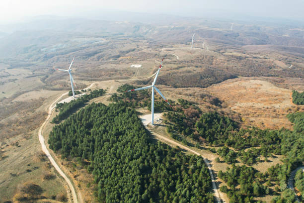 istock wind turbines among pine trees, electricity generation from wind renewable electricity generation, drone view of wind turbines 1441183803