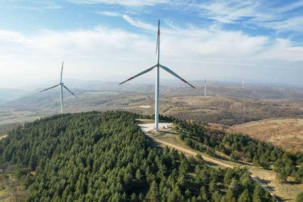 istock wind turbines among pine trees, electricity generation from wind renewable electricity generation, drone view of wind turbines 1441183932