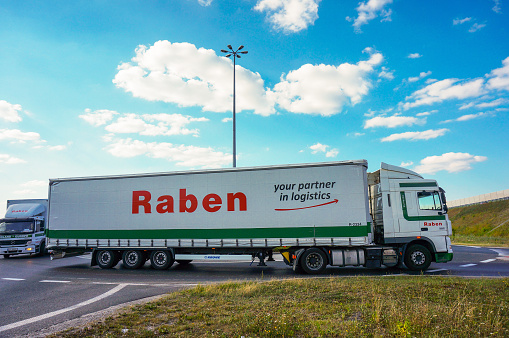 Poznan, Poland – February 13, 2016: Raben company transport truck driving on a roundabout