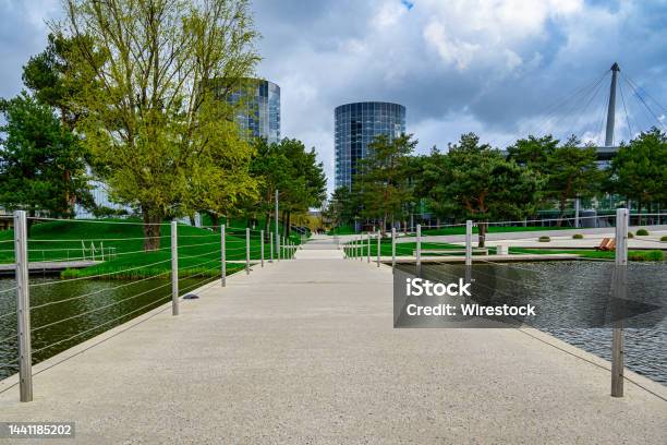 Beautiful Footbridge Over A Calm Lake In The Green Autostadt Park In Wolfsburg Germany Stock Photo - Download Image Now