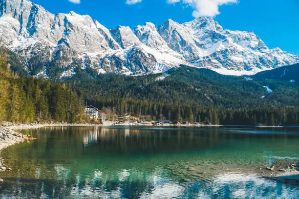 The beautiful scenery of Eibsee lake in Garmisch-Partenkirchen, Germany with snow covered mountains background
