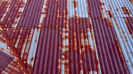 Its rusted tin roof made it seem abstract because of its irregular rust