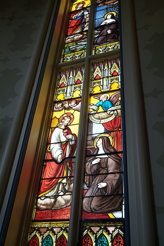 South Bend, United States – August 18, 2007: A stained glass window in the Basilica of the Sacred Heart church at Notre Dame University in South Bend, Indiana.