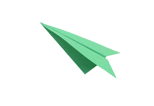 Green paper plane on white background