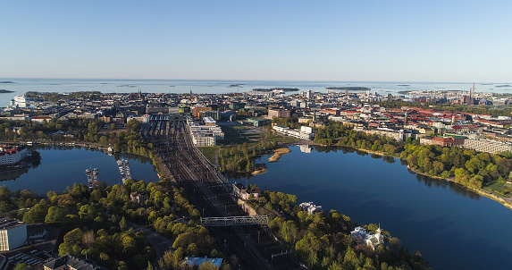 Aerial view of the downtown Helsinki cityscape and lake Toolonlahti, at golden hour sunrise, in Finland