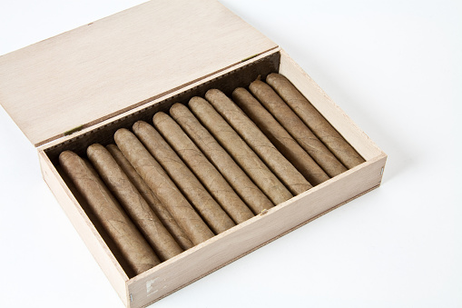 A high-angle shot of elite cigars isolated on a white background