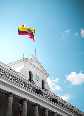 A scenic view of the Ecuadorian National flag on Carondelet Palace at Independence Square in Ecuador