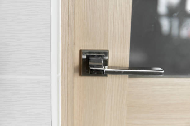 istock Chrome interior door handle installed on a kitchen door with a glass elements. 1441187120