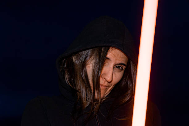 istock Cosplayer woman with a LED lightsaber 1441187185