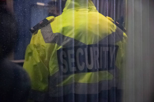istock Security guard standing inside commercial building nearby the wi 1441187895