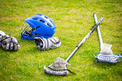 Lacrosse match, players, gear on the field, american sports themed photograph.
