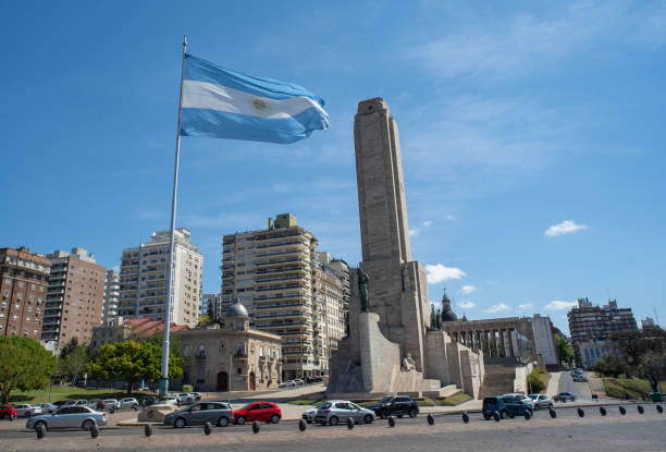 Rosario, Argentina – October 06, 2020: General shot of the National Flag Memorial where you can see the flag on the mast flapping in the wind on a sunny day with many cars circulating