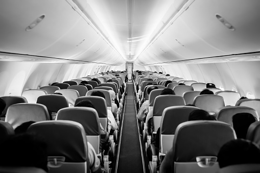 View of and aisle of a modern jetliner.