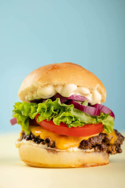 istock Vertical shot of a hamburger on an isolated colored background 1441190925
