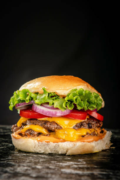 istock Vertical shot of a hamburger on an isolated black background 1441191701