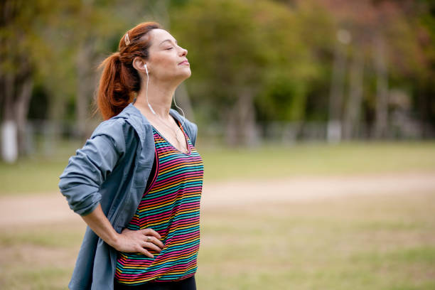 istock Woman breathing after exercises outdoors in a park 1441191896
