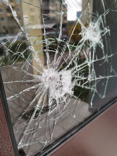istock Vertical shot of a broken glass window 1441192019