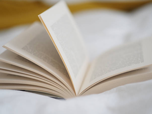 istock Selective focus shot of an open book on a white cloth 1441192267