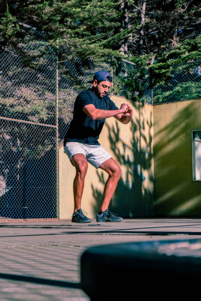 istock Latino male athlete doing squats sit-up  exercise. Outdoors, forest background. 1441193985