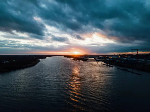 Droneshot of a sunset at a river in Belgium.
