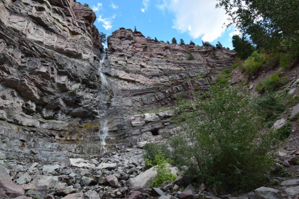 istock Waterfall from rocky cliff in mountain forest 1441194967