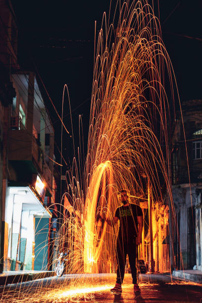 istock Vertical shot of a Hispanic young man making steel wool fireworks 1441196392