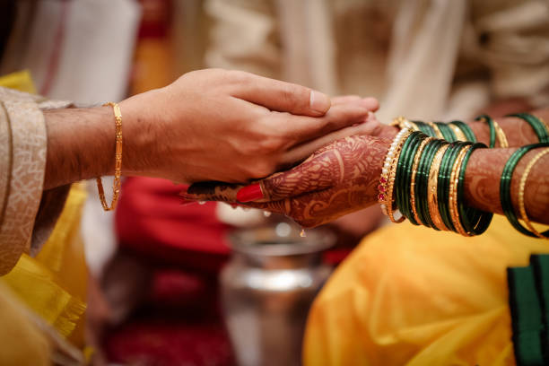 istock Selective focus shot of an Indian couple's hands at a wedding 1441196572