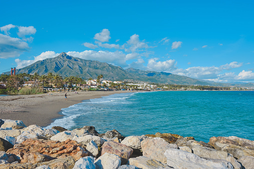 The beautiful scenery of people by the sand in Marbella, Spain