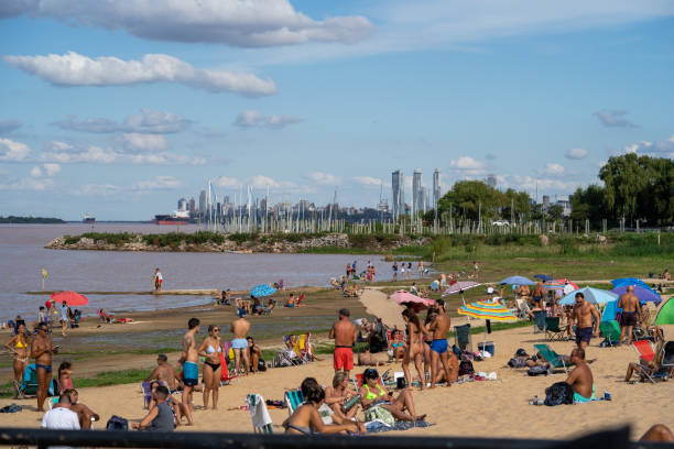 Rosario, Argentina – May 19, 2021: People vacationing on Rambla Catalunya beach on the Parana river without social distance on a sunny day