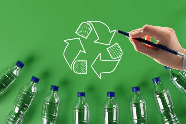 istock Plastic bottles with the recycling icon and painted recycling arrows. 1441197323