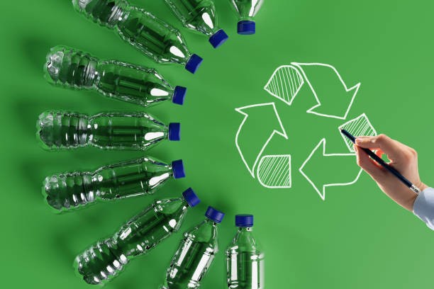 Plastic bottles with the recycling icon and painted recycling arrows.