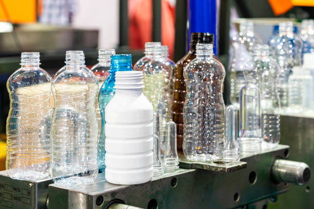 istock various sample transparent plastic bottle and other color with  preform raw material place on metal mold of manufacturing process bottle blowing in industrial 1441199259