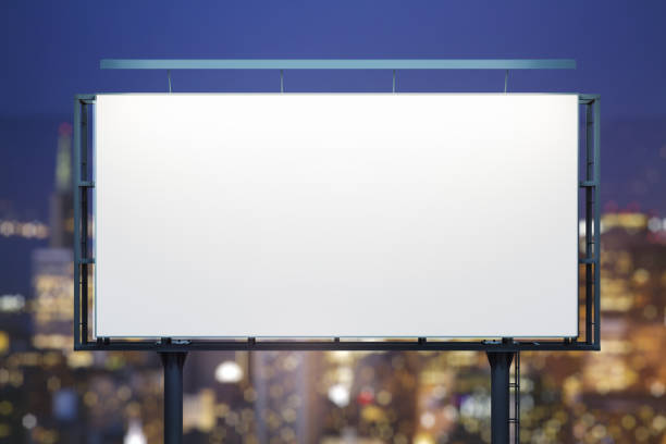 istock Blank white billboard on cityscape background at evening, front view. Mock up, advertising concept 1441199307