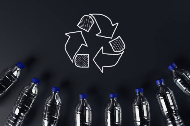 istock Plastic bottles with the recycling icon and painted recycling arrows. 1441199497