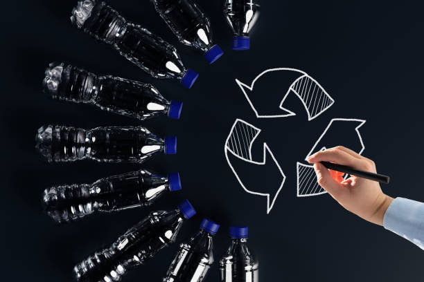 istock Plastic bottles with the recycling icon and painted recycling arrows. 1441199516