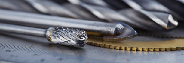 istock set of different drill bits,thread tap and mill cutters with caliper ruler on steel plate background. Locksmithing deal. 1441201506