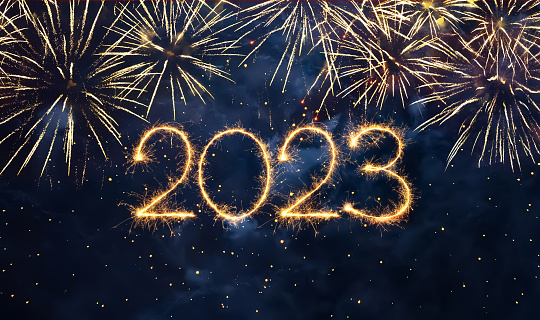 Happy New Year 2023. Beautiful holiday web banner or flyer with Golden firework and sparkling number 2023 on night blue sky background.