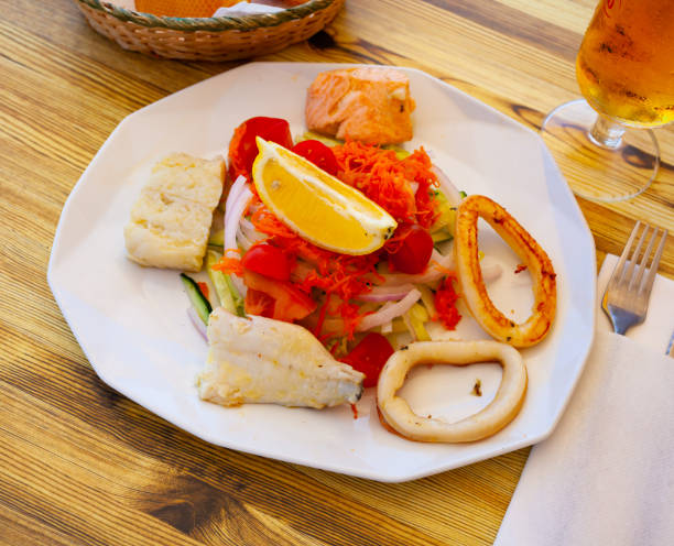 istock Seafood salad with grilled squid, salmon and vegetables 1441206917