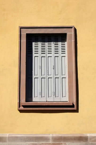 istock Vintage Wooden Window on Stucco Wall Background in Minimal Style. 1441208151