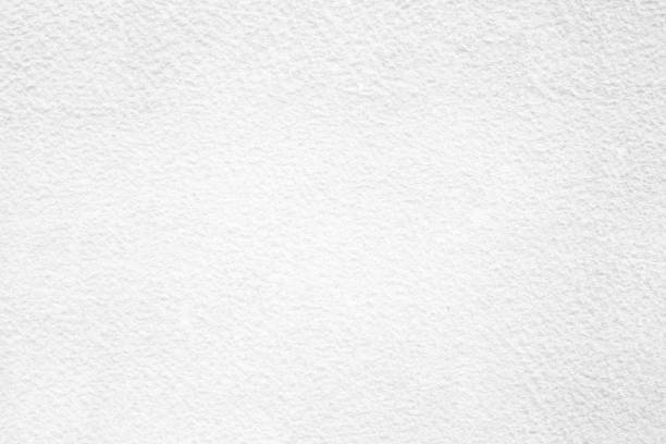 istock White Raw Concrete Wall Texture Background Suitable for Presentation and Web Templates with Space for Text. 1441208354
