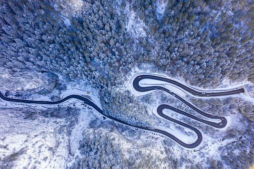 Above view of curvy road in winter. Bicaz Gorges is a narrow pass in Romanian Carpathians between Moldavia and Transylvania