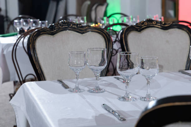 istock Elegant table setting dinner in a restaurant. Table setting for an event party or wedding reception. Empty glasses and dishes. 1441211859