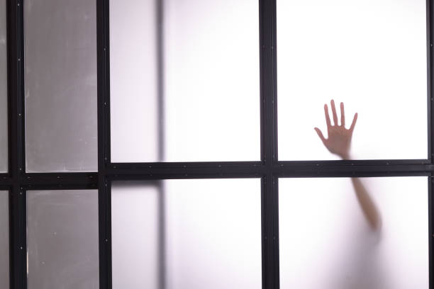 istock Diffused Silhouette of a women's hands through frosted glass 1441211898