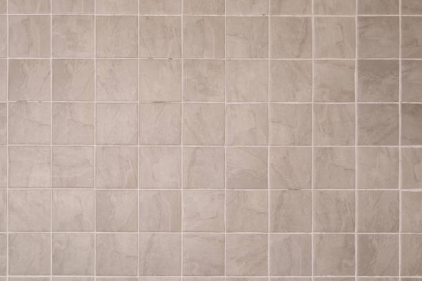istock Close up grey ceramic tiles with white filling bathroom wall texture background. 1441212198